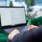 Digital marketer using ChatGPT AI tool for content creation, SEO, social media marketing, and campaign automation on a laptop.